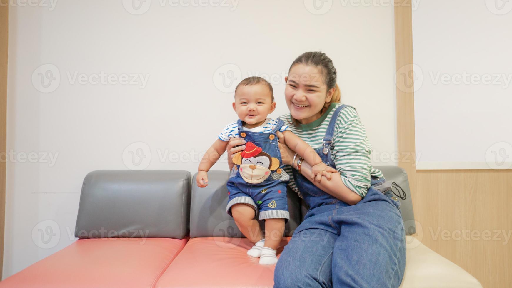 Child sitting and playing with toy smiling looking cute Focusing only on the child in the center of the picture There is a slight blur in the surrounding area intended to provide images with depth photo