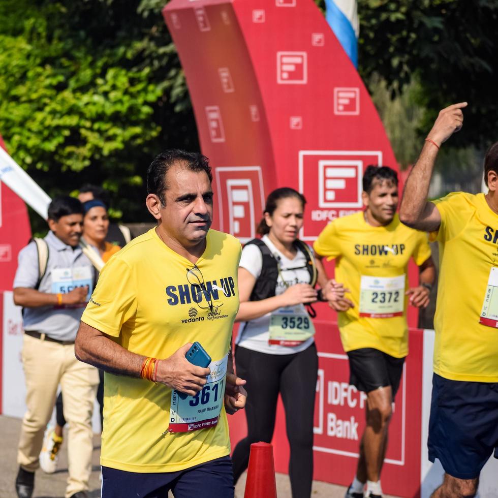 New Delhi, India - October 16 2022 - Vedanta Delhi Half Marathon race after covid in which marathon participants about to cross the finish line, Delhi Half Marathon 2022 photo