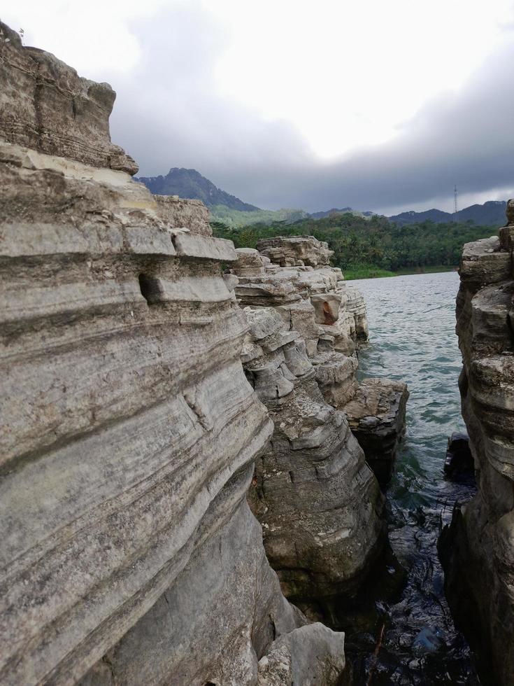 Hole stone and lake background free photo