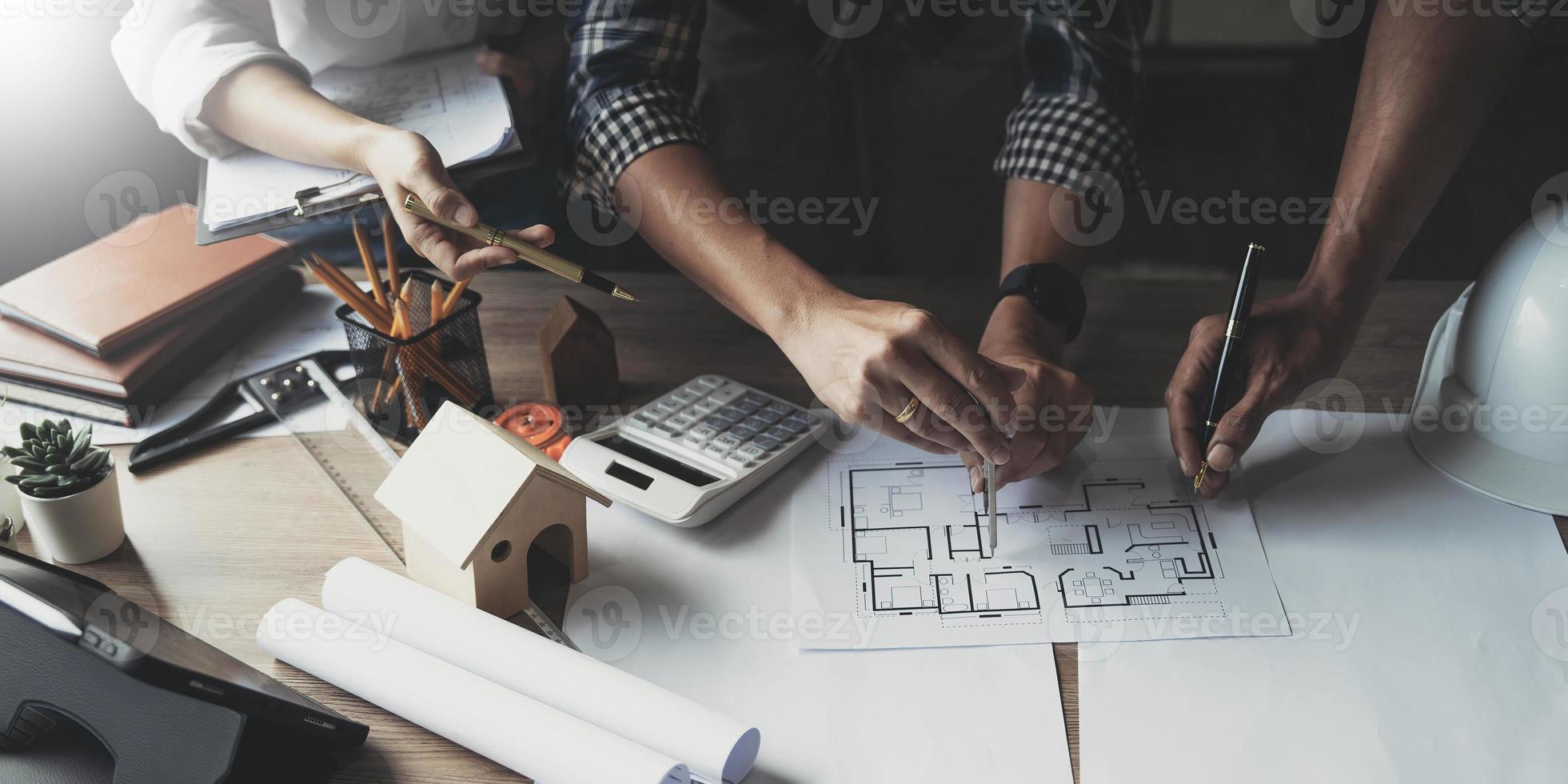 Team construction engineers working at construction site with blueprint on table photo