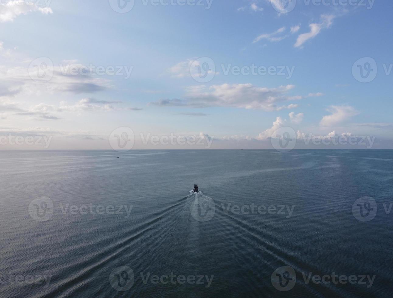 Aerial view fishing boat move at sea photo