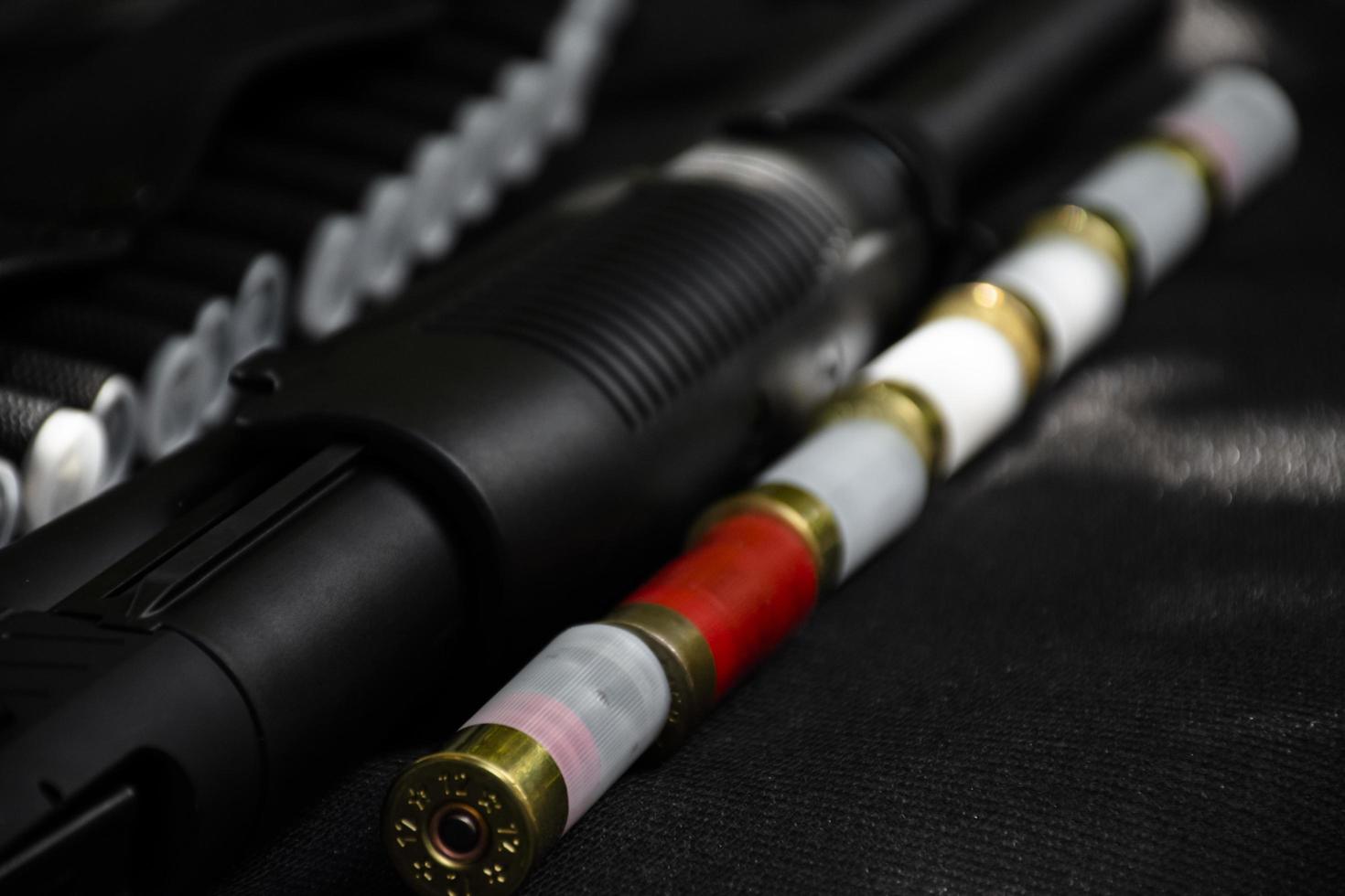 Shotshell bullets near shotgun, soft and selective focus. photo