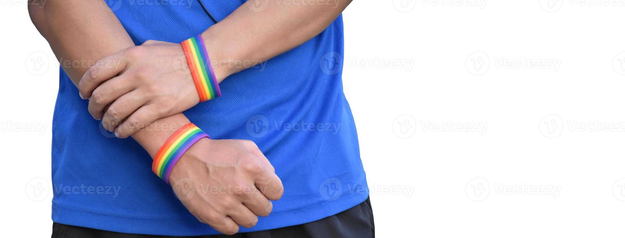 Rainbow wristband on right and left hand, soft and selective focus photo