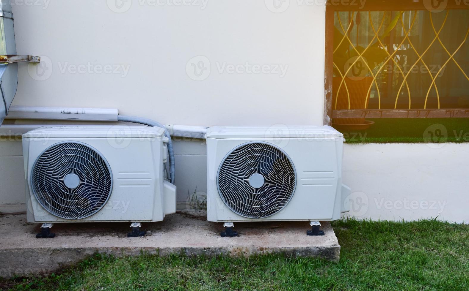 White two units of conditioning ventilator installed on the cement floor of the building, soft and selective focus. photo