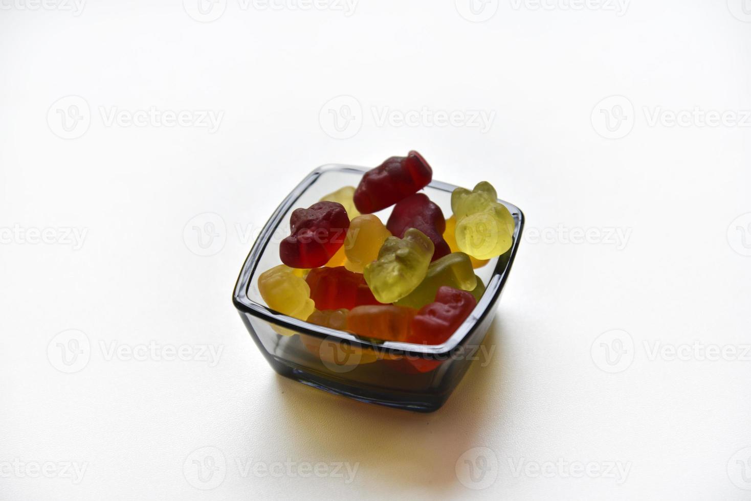 Delicious marmalade jelly bears candy in a package on a white background. A sweet snack in the form of jelly colorful delicious animals. photo