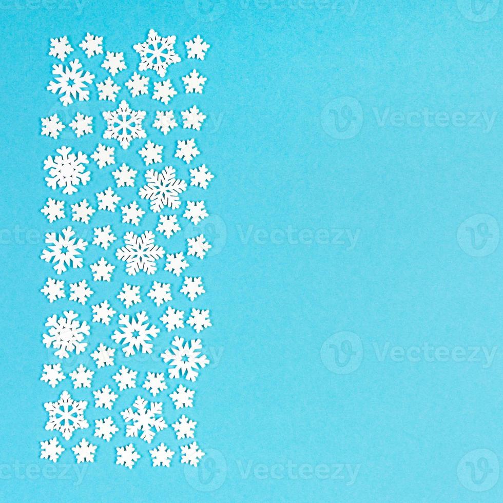 Top view of winter ornament made of white snowflakes on colorful background. Happy New Year concept with copy space photo