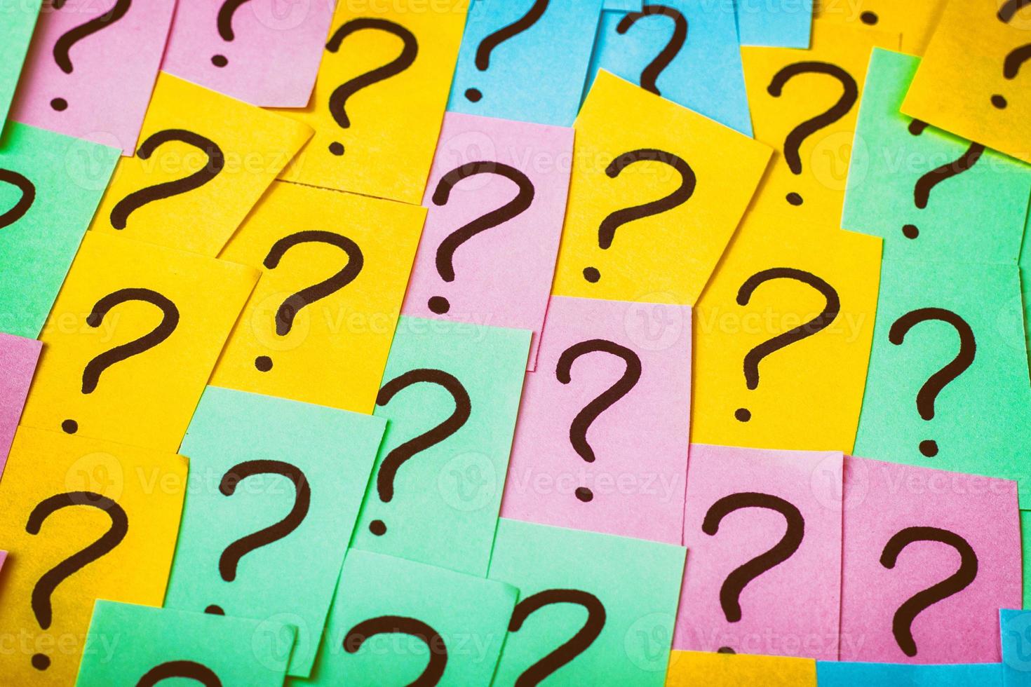 Question marks background. Colorful paper notes with question marks. Concept image. Closeup top view toned photo