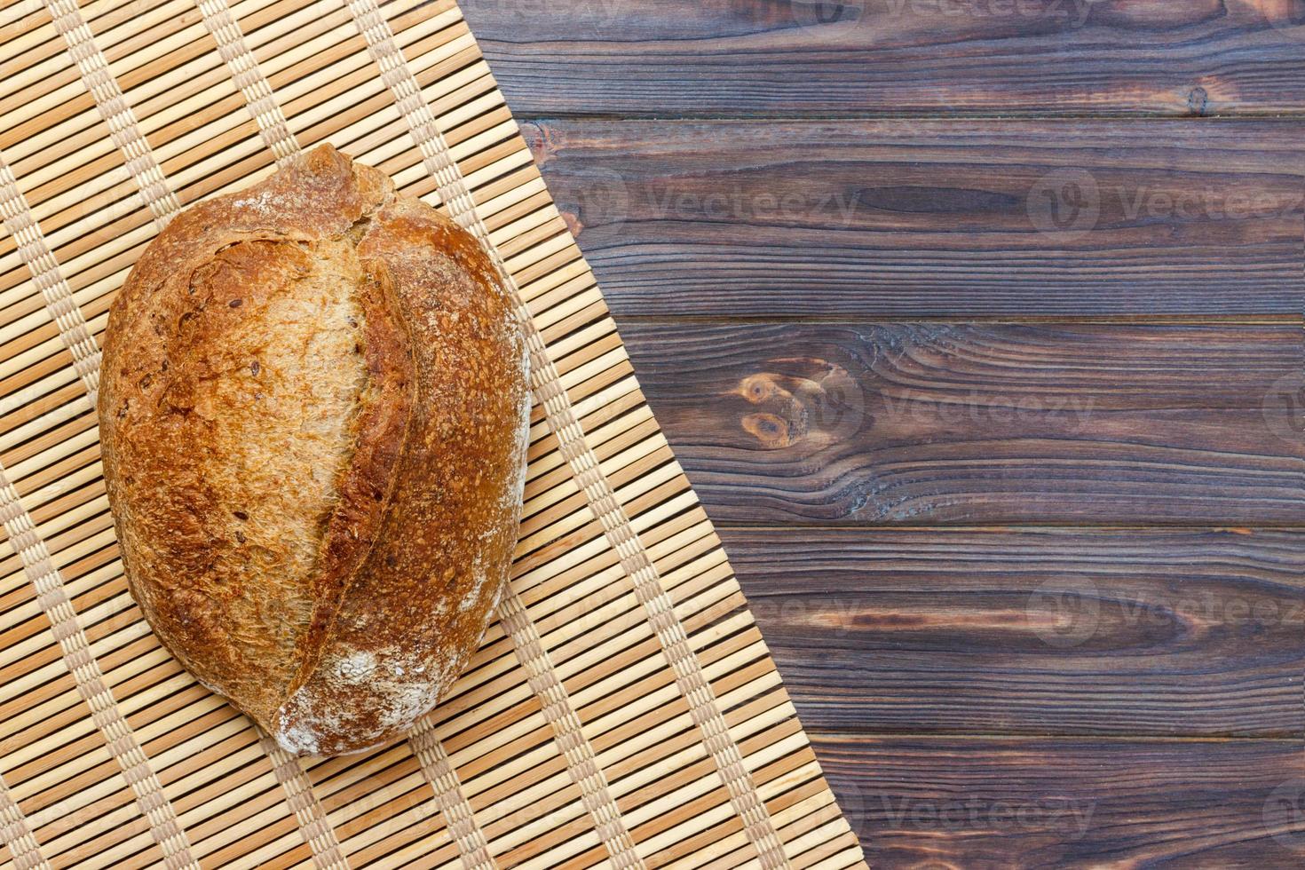 Fresh bread on wooden table. Top view with space for your text photo