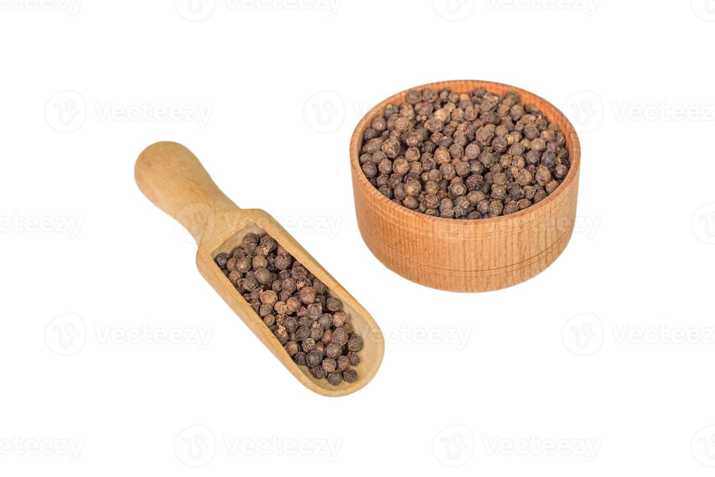 allspice in a wooden bowl. Black pepper. isolated on white background. photo