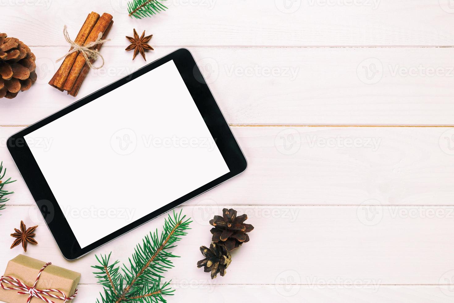 Digital tablet mock up with rustic Christmas wooden background decorations for app presentation. top view vintage, toned with copy space photo