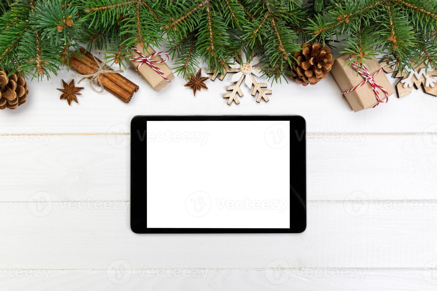 Digital tablet mock up with rustic Christmas wooden background decorations for app presentation. top view with copy space photo