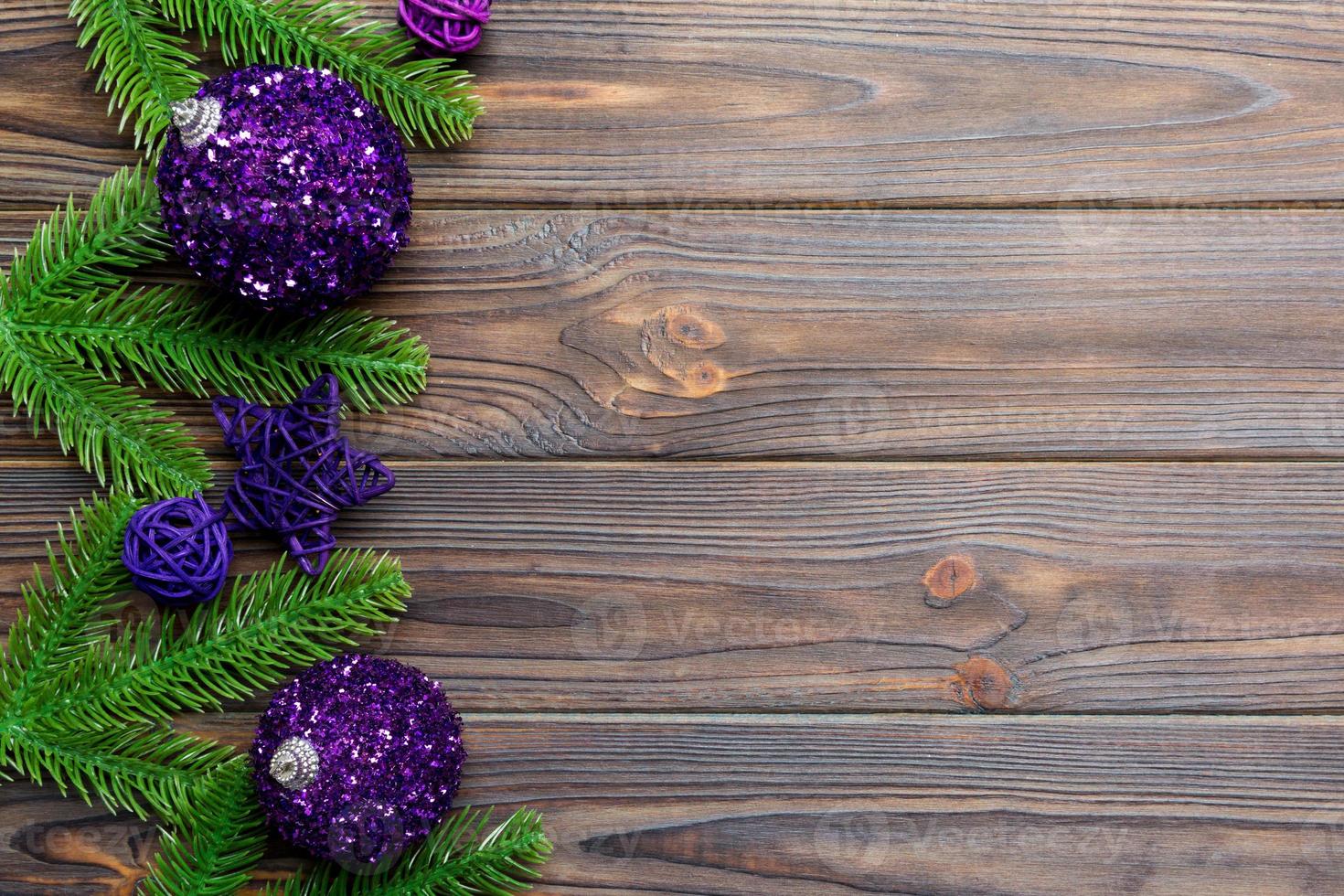 Christmas composition made of fir tree, balls and different decorations on wooden background. Top view of New Year Advent concept with empty space for your design photo