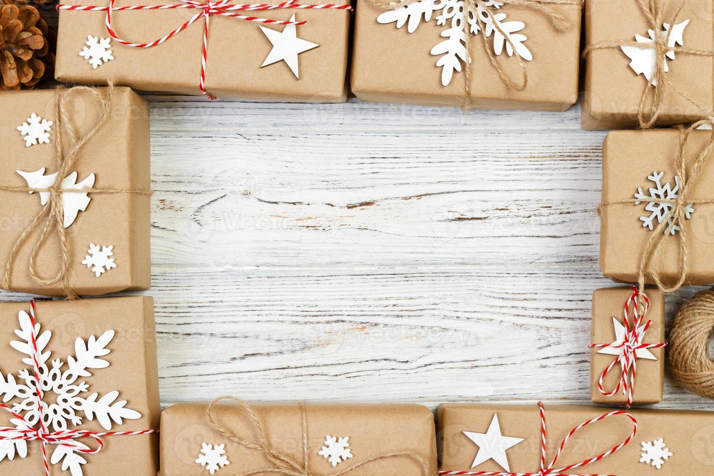 New Year and Christmas Frame Composition. handmade wrapped christmas gift boxes with decoration on white background with empty copy space for your text. above view, flat lay photo
