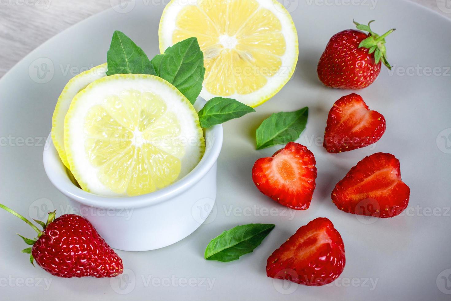 Lemon, mint and strawberries. photo