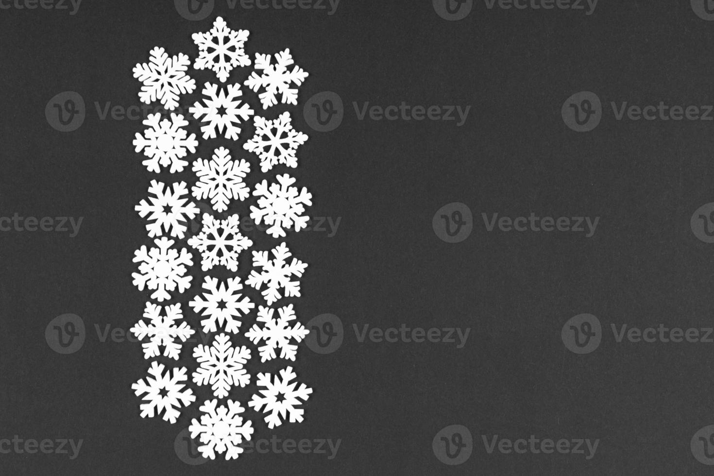 Top view of white snowflakes on colorful background. Winter weather concept with copy space. Merry Christmas concept photo