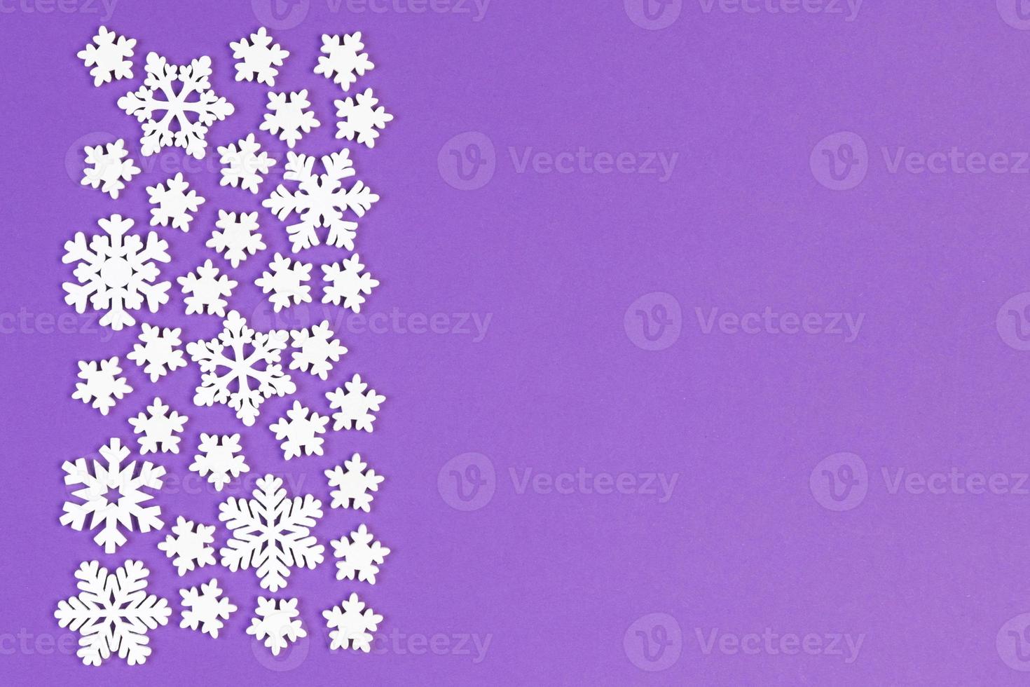 Top view of white snowflakes on colorful background. Winter weather concept with copy space. Merry Christmas concept photo