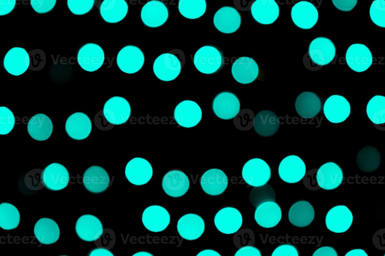 Unfocused abstract colourful bokeh black background. defocused and blurred many round blue light photo