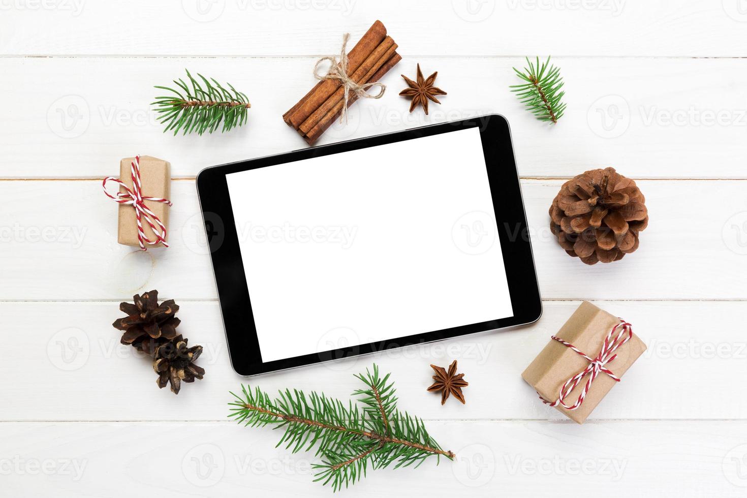 Digital tablet mock up with rustic Christmas wooden background decorations for app presentation. top view with copy space photo