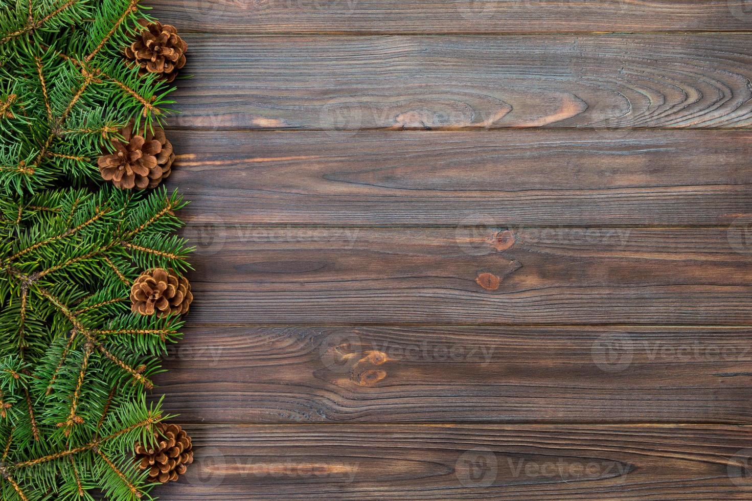 Christmas gray wooden background with fir tree frame and cones copy space. top view empty space for your design photo