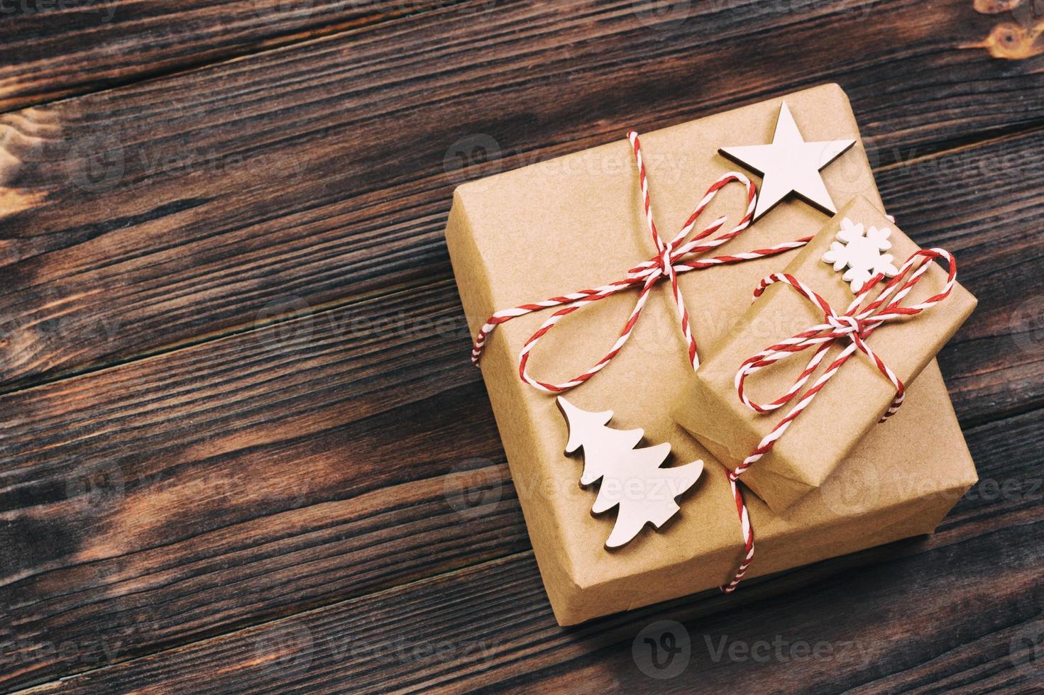 Christmas wooden decorations with snowflakes, white stars and Xmas trees on a background of black vintage old wooden boards. Background for your text and design photo