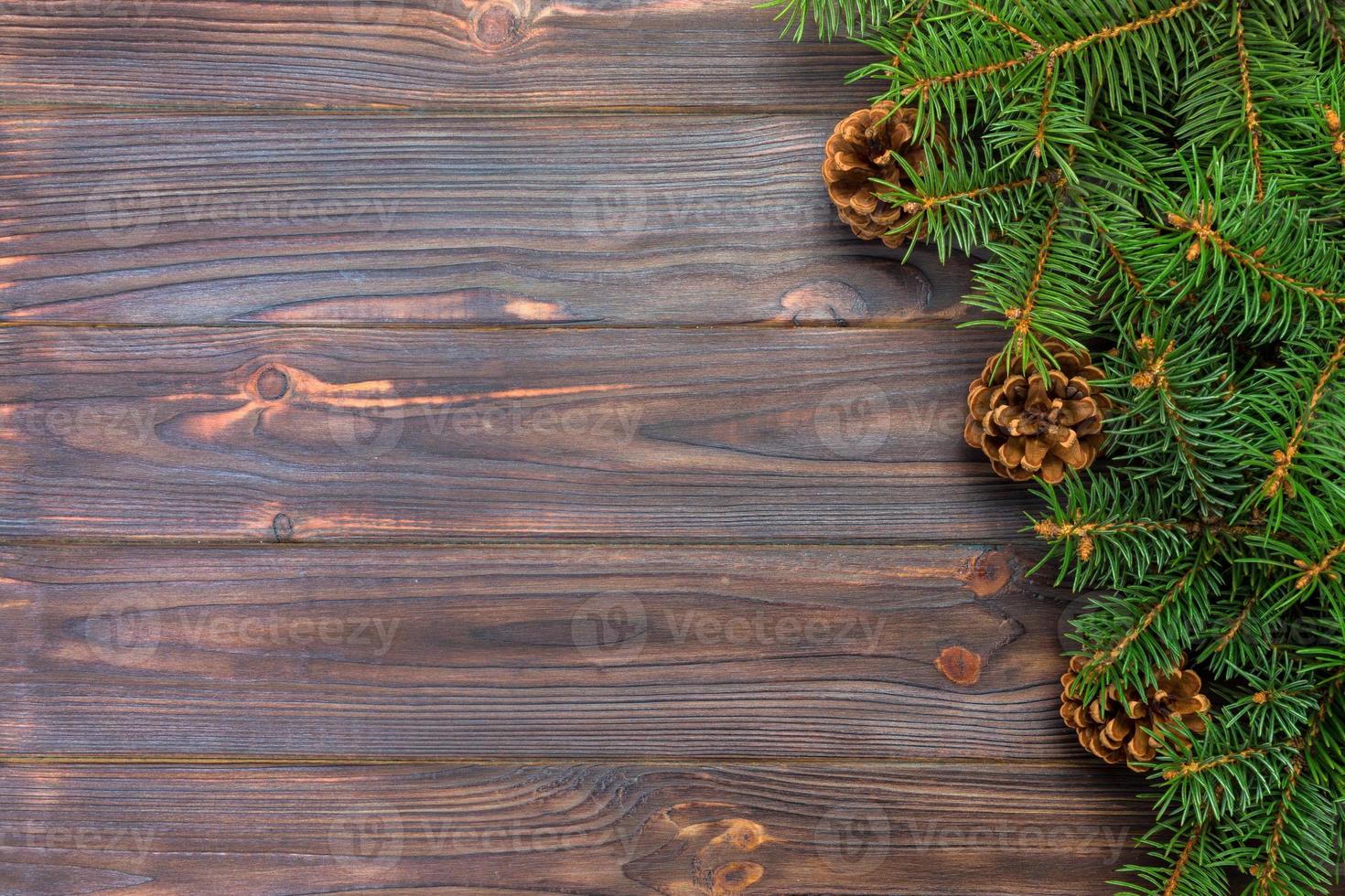Christmas gray wooden background with fir tree frame and cones copy space. top view empty space for your design photo
