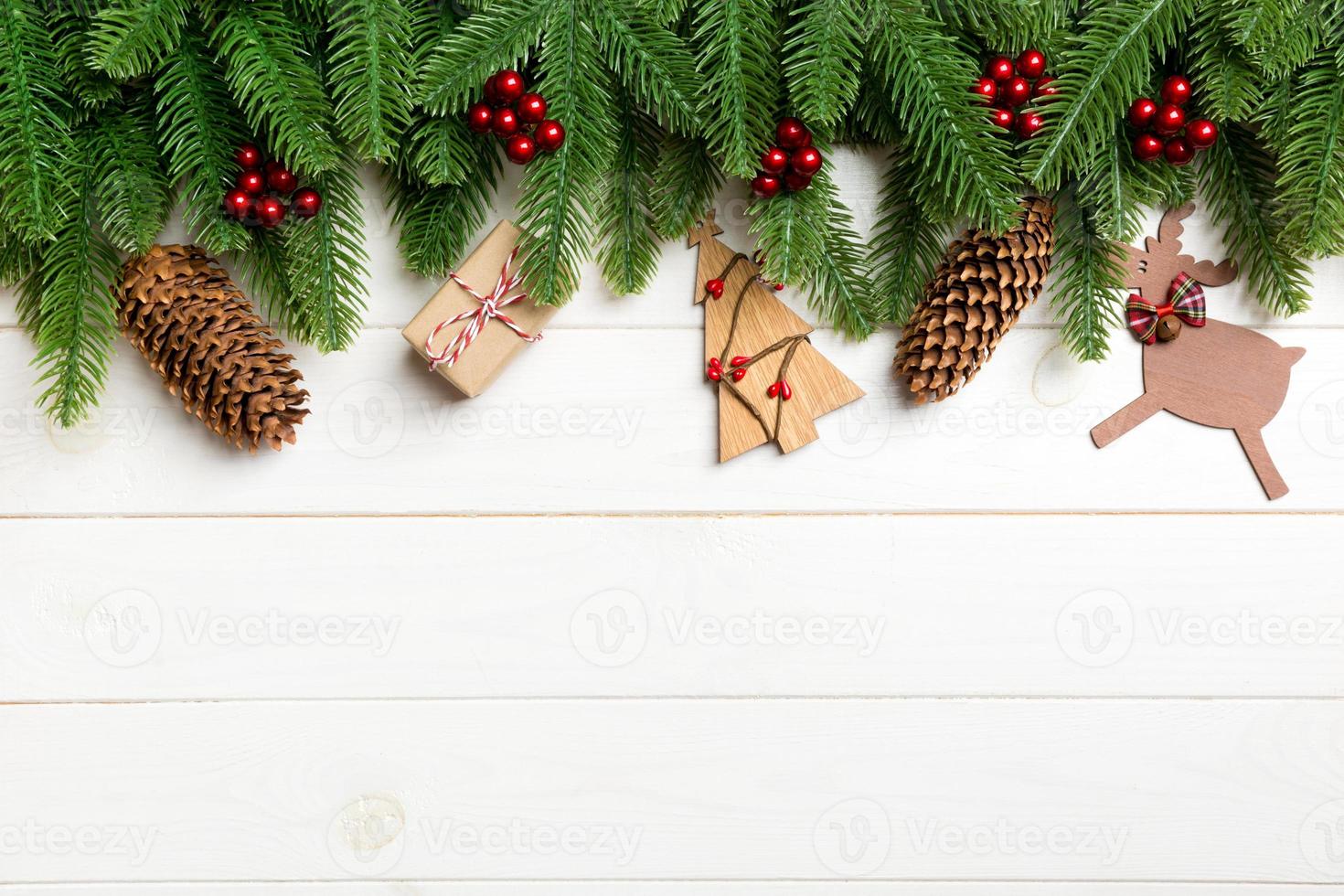 Top view of fir tree and New Year decorations on wooden background. Christmas concept with copy space photo