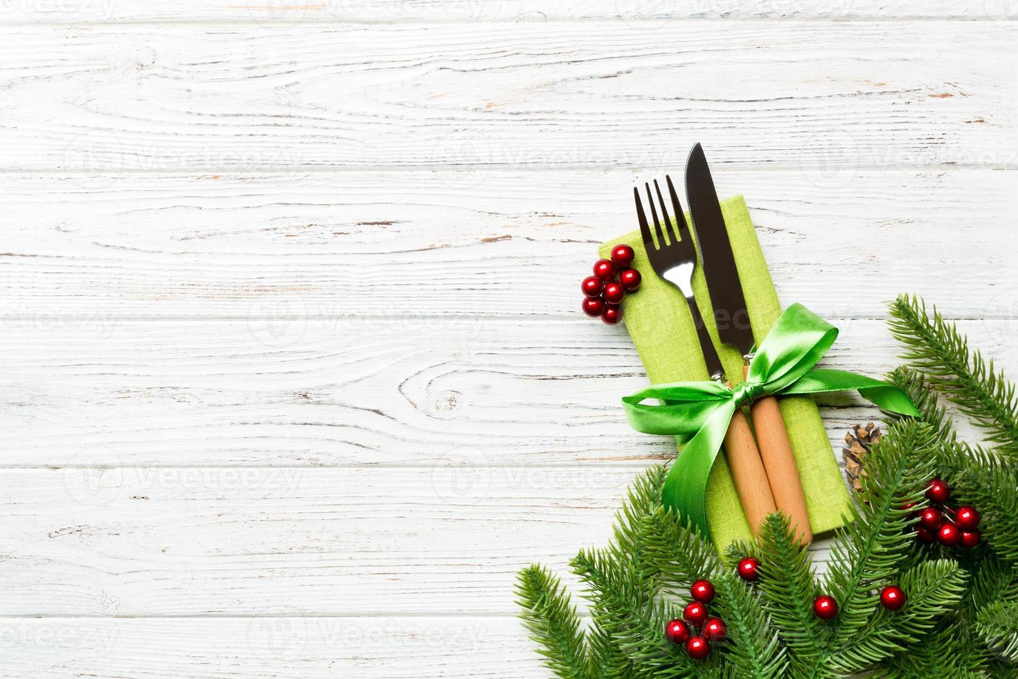 Top view of festive cutlery on new year wooden background. Christmas decorations with empty space for your design. Holiday dinner concept photo