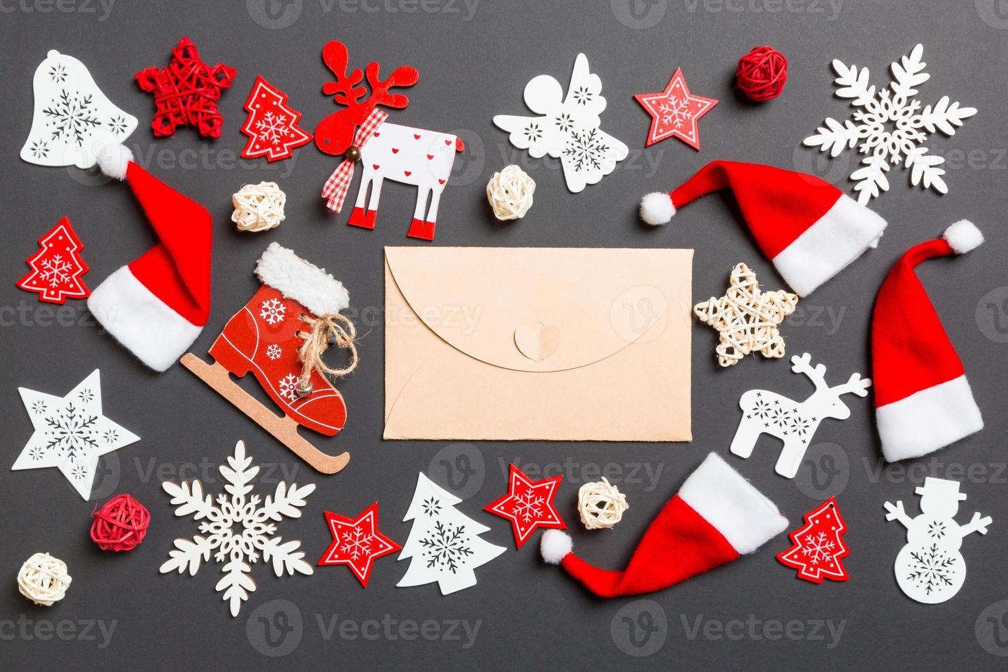 Top view of craft envelope. New Year decorations on black background. Merry Christmas concept photo