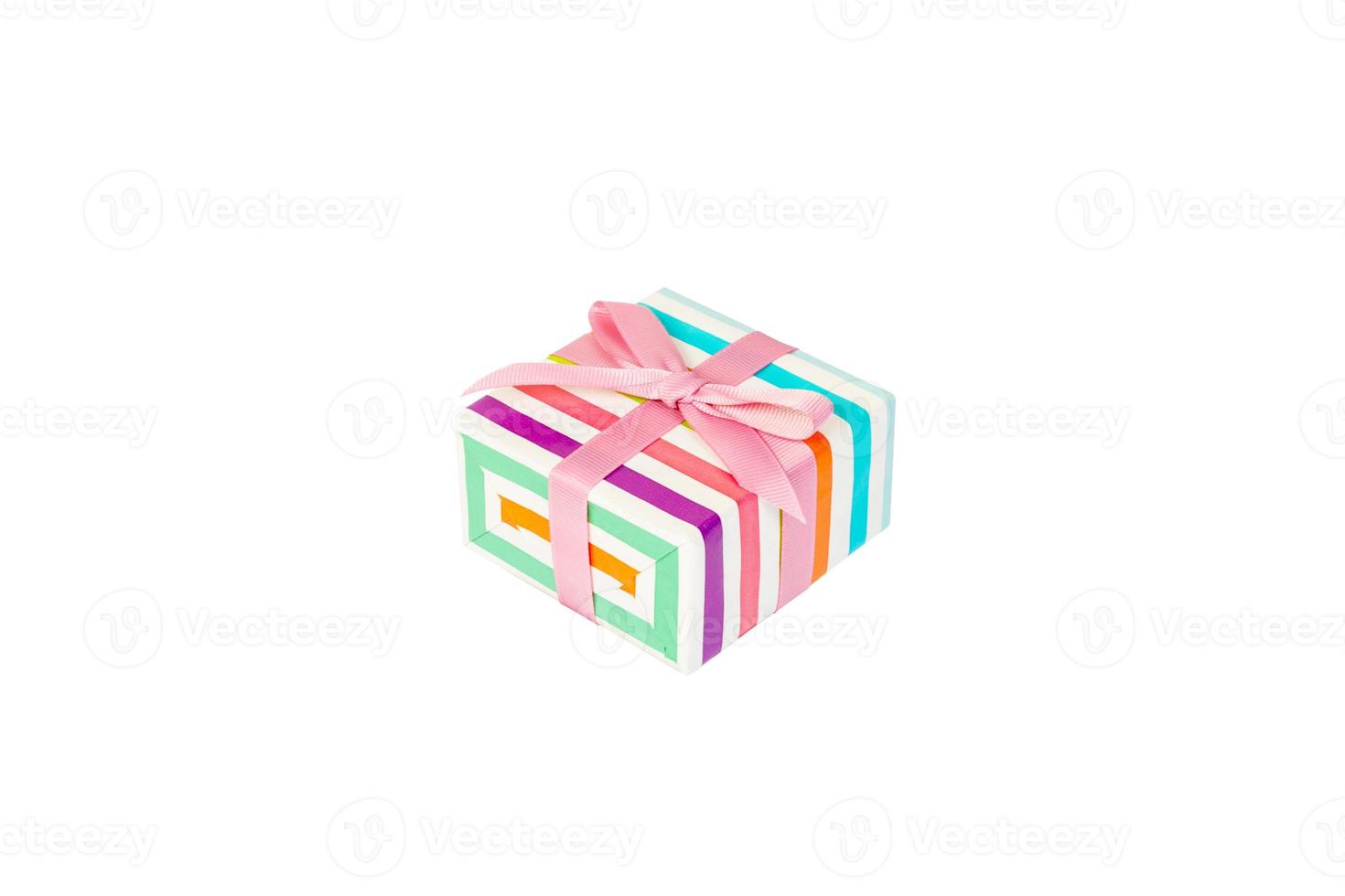 Christmas or other holiday handmade present in colored paper with pink ribbon. Isolated on white background, top view. thanksgiving Gift box concept photo