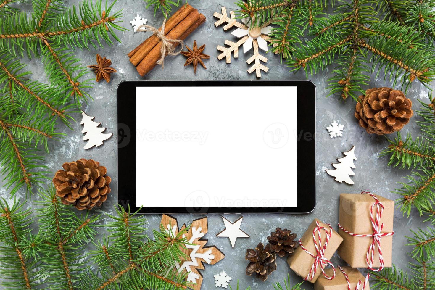 Digital tablet mock up with rustic Christmas gray cement background decorations for app presentation. top view with copy space photo