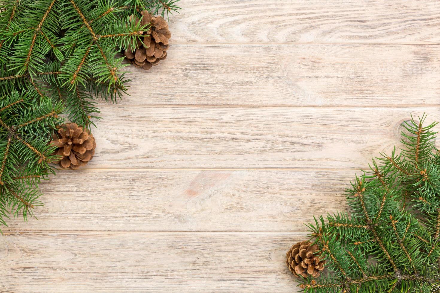 Christmas gray wooden background with fir tree frame and cones copy space. top view empty space for your design photo