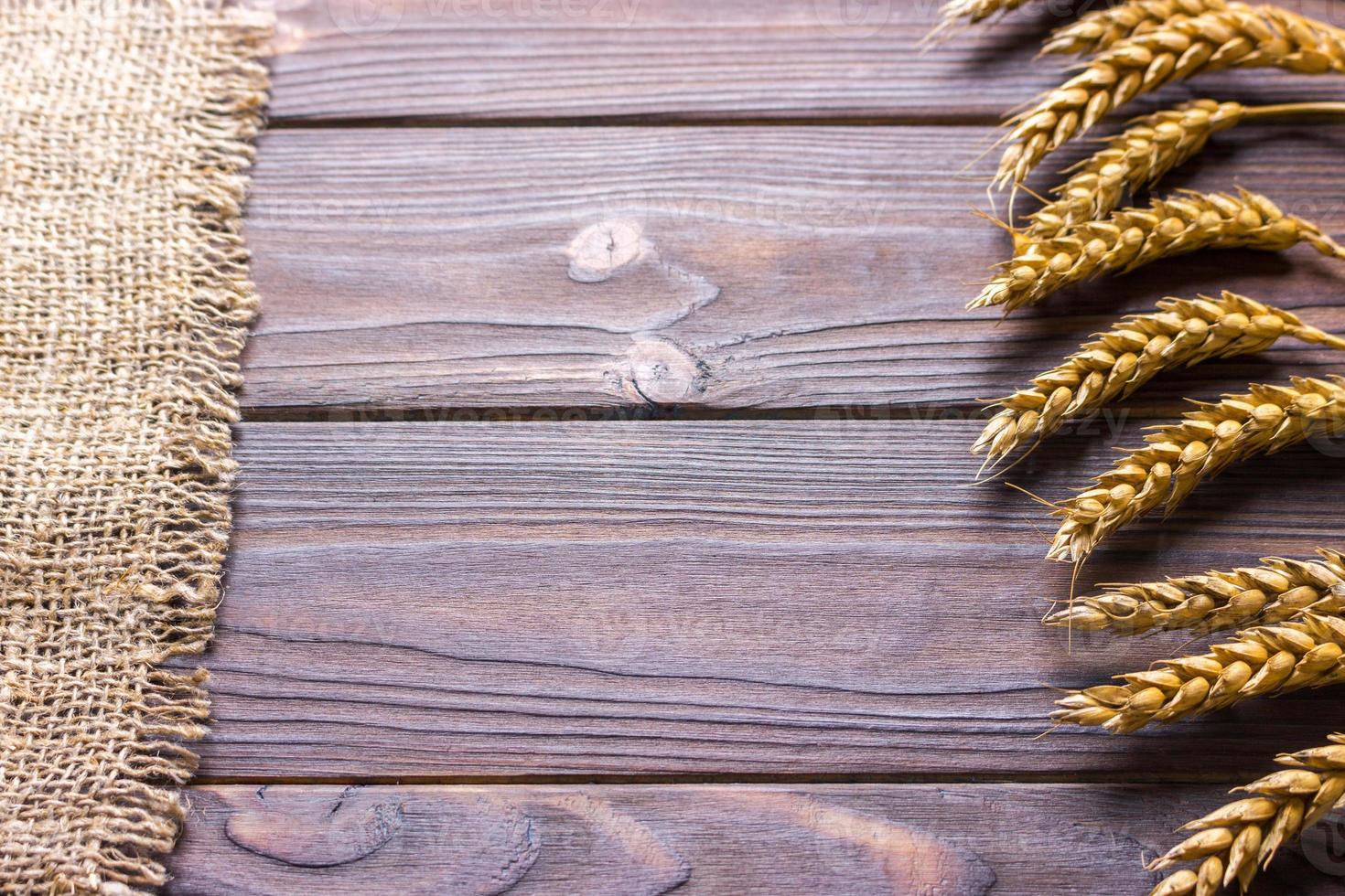 burlap hessian sacking on wooden background Harvest concept photo