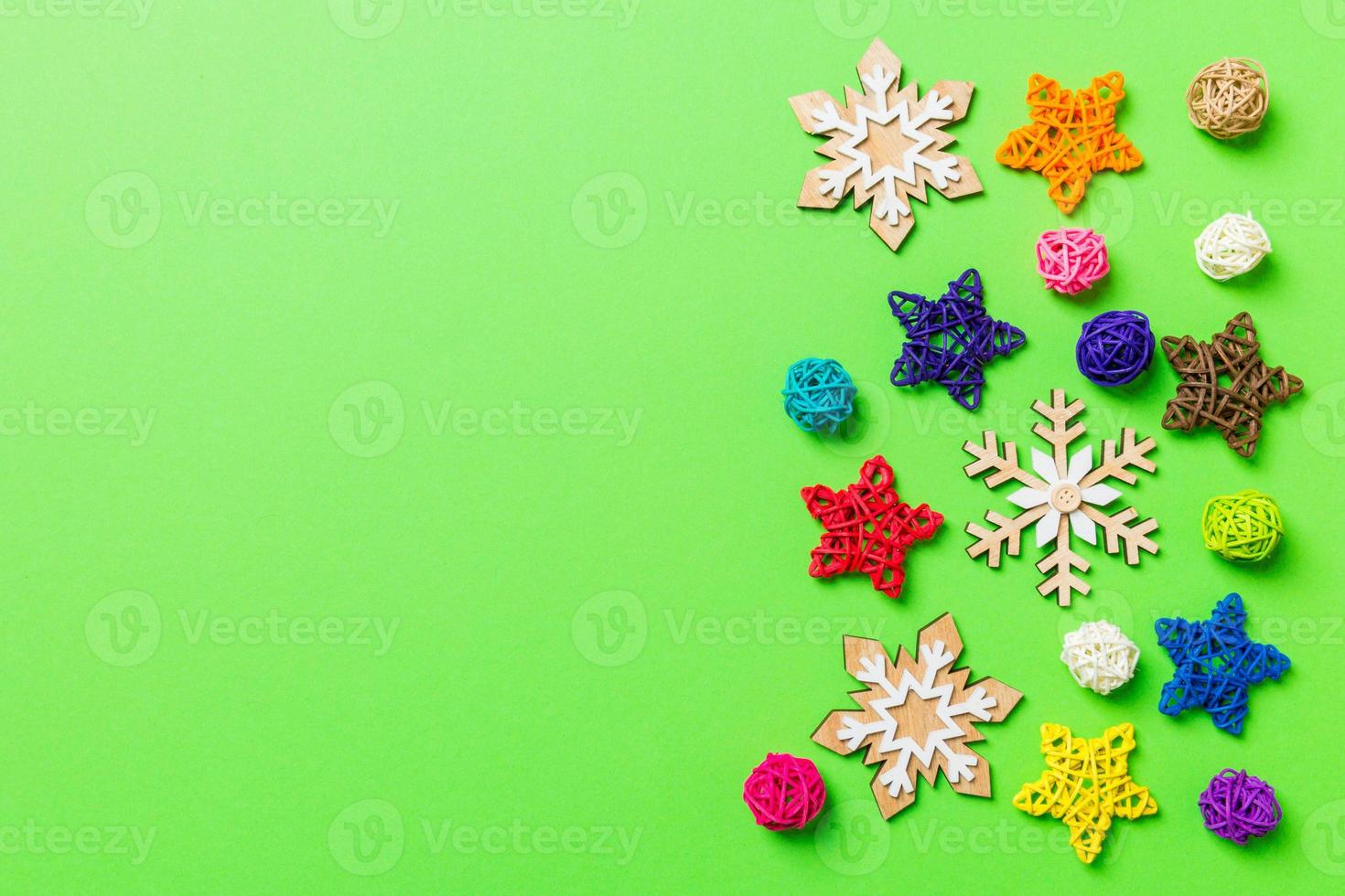New Year decorations on green background. Festive stars and balls. Merry Christmas concept with empty space for your design photo