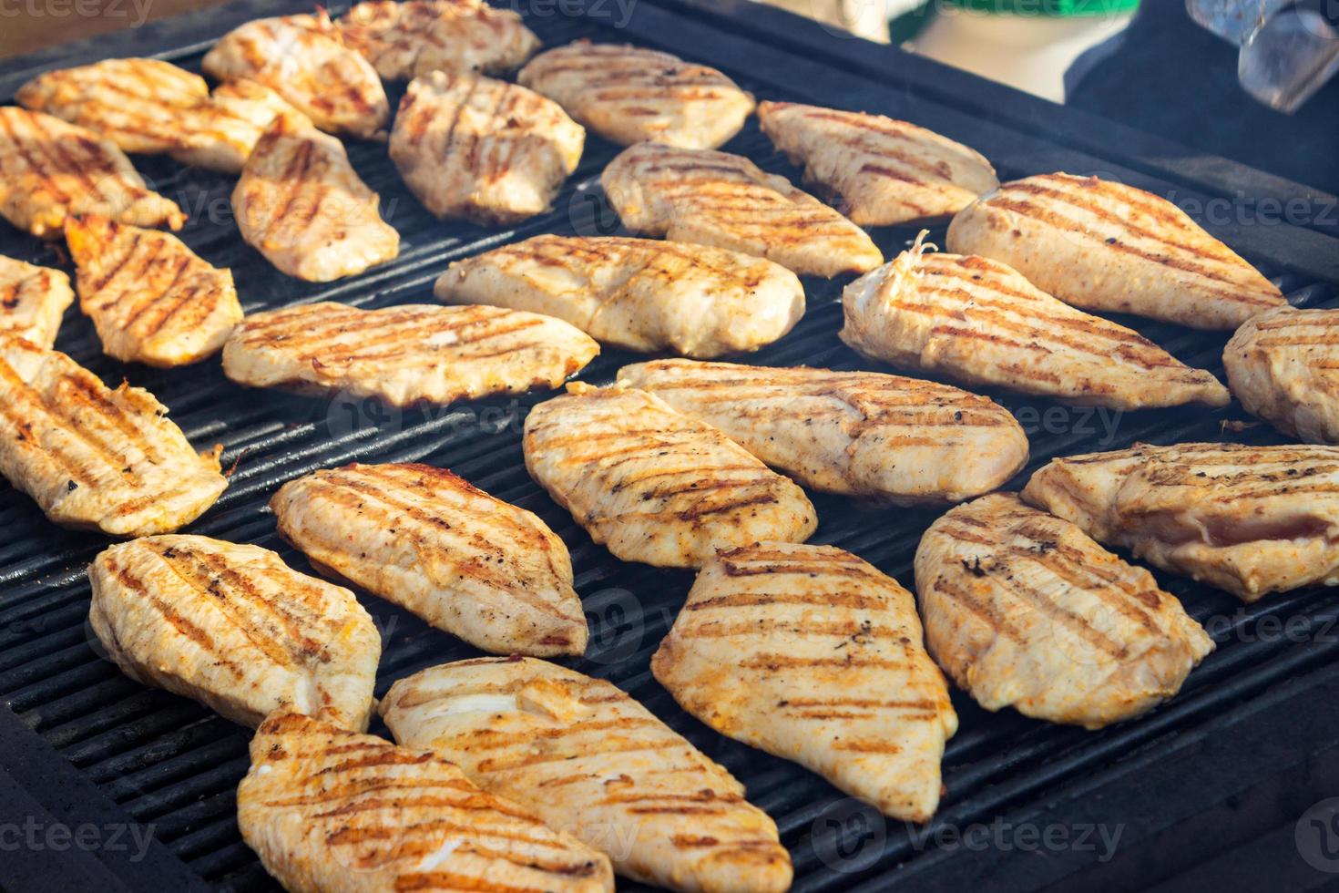 grilled chicken fillets on the barbecue. Street food. photo