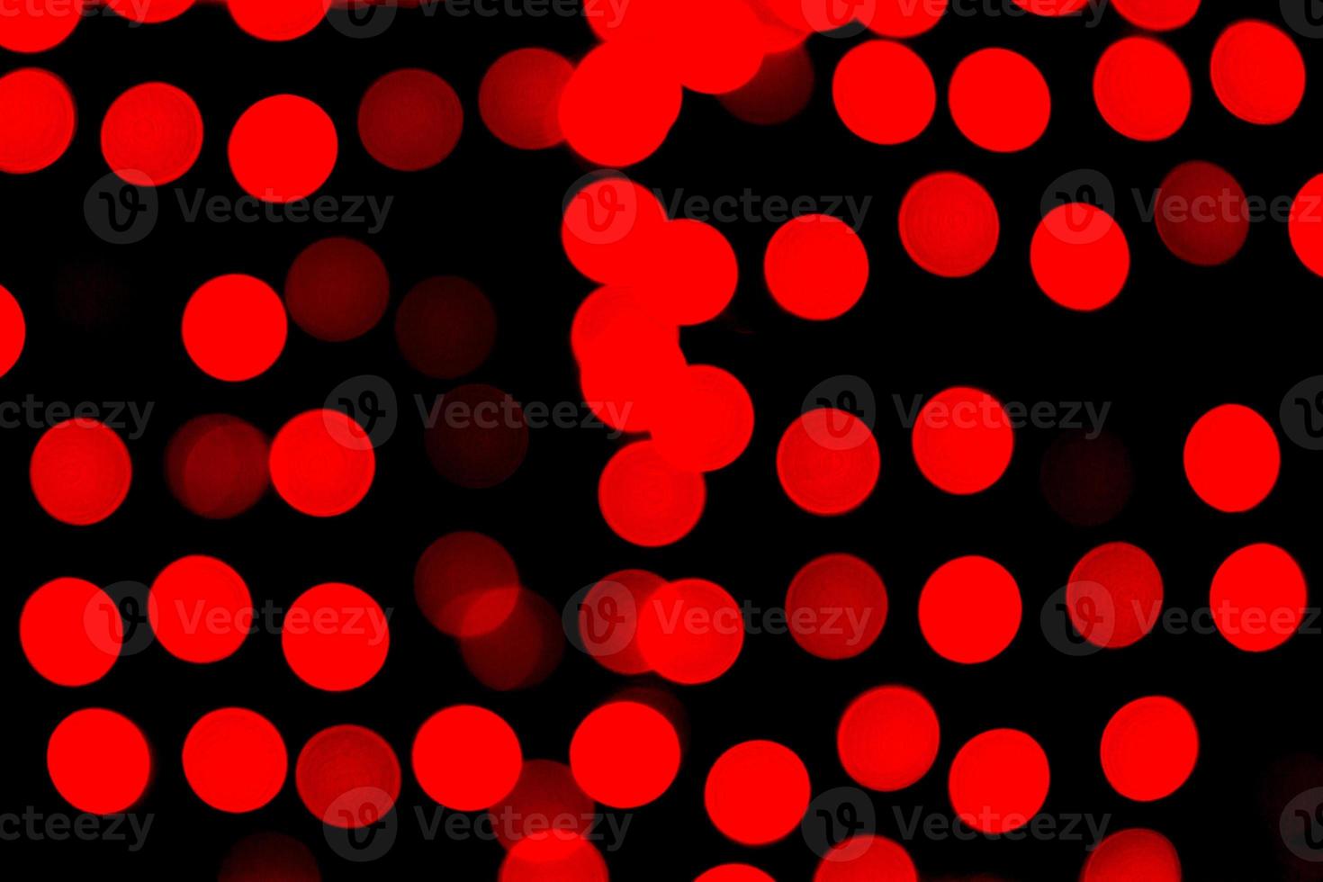 Unfocused abstract red bokeh on black background. defocused and blurred many round light photo