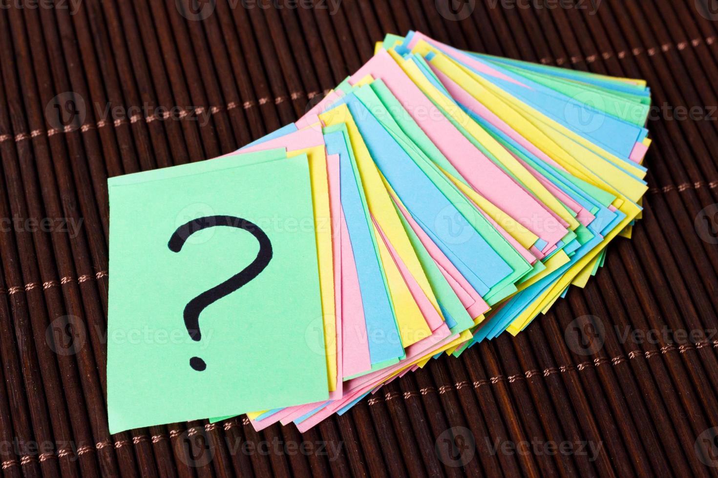 Question mark paper heap on table concept for confusion photo
