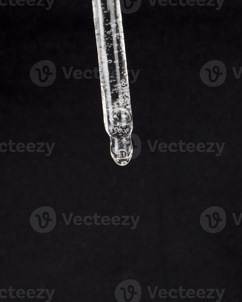 pipette with medicine on a black background, cannabis extract drop photo