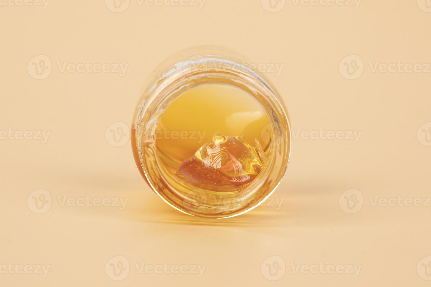 yellow cannabis wax in glass container, golden thc dab photo