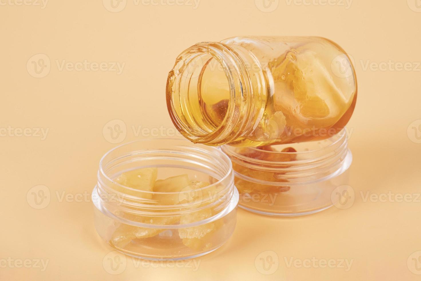 bottles of amber golden cannabis wax with high THC content photo