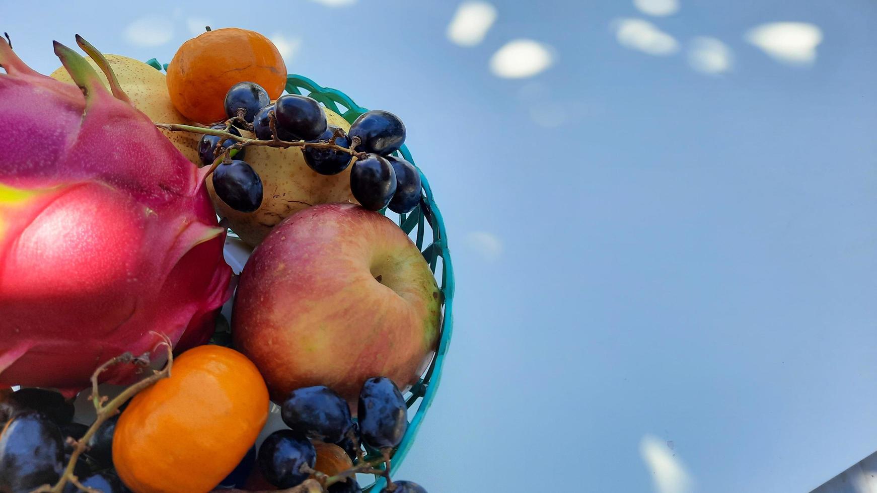 Top angle, tropical fruit grapes, oranges, dragon fruit, pears and apples on a white background 01 photo