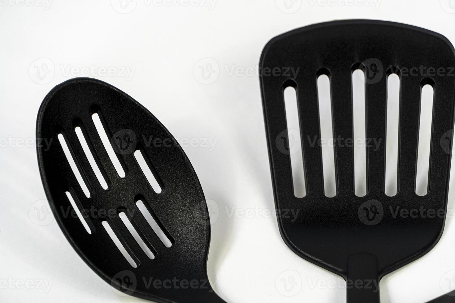 black plastic kitchen utensils isolated on white. Clipping path included. mexico photo