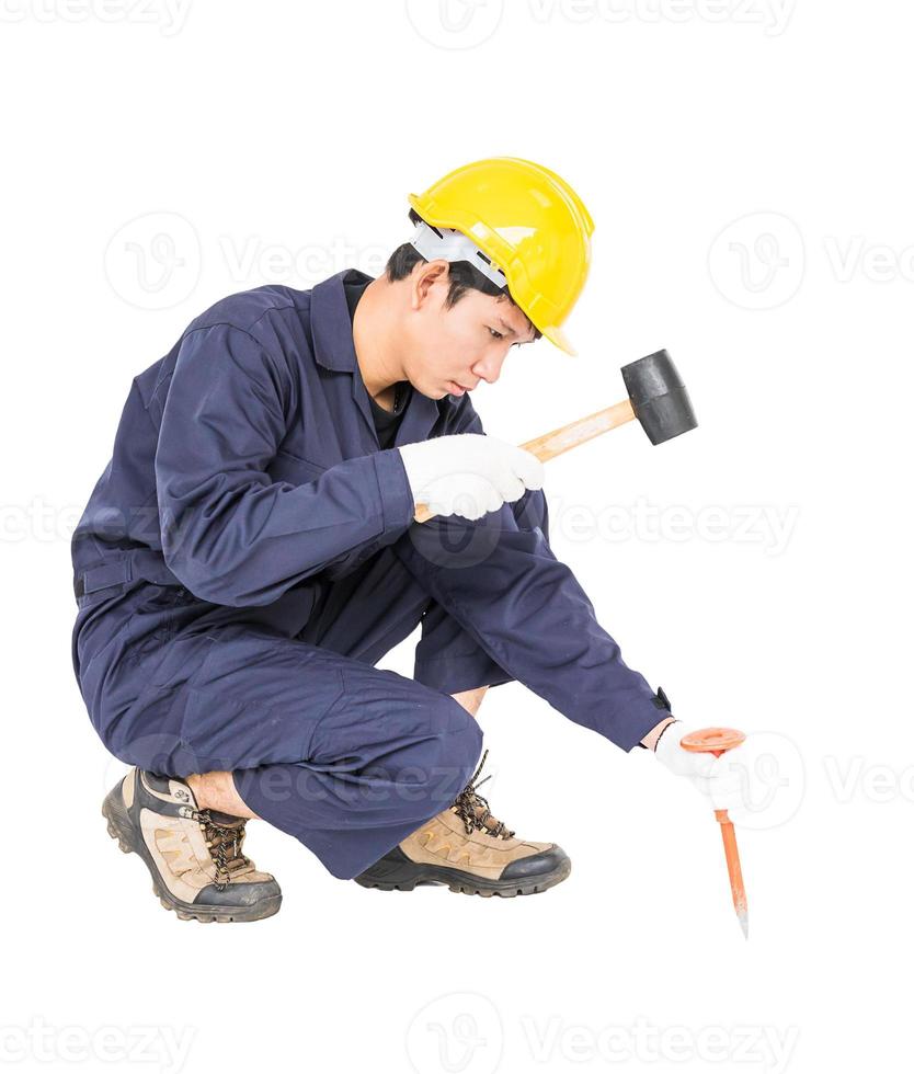 Man hold hammer and cold chisel on white photo