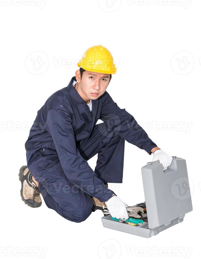 Young handyman sitting with his tool box photo