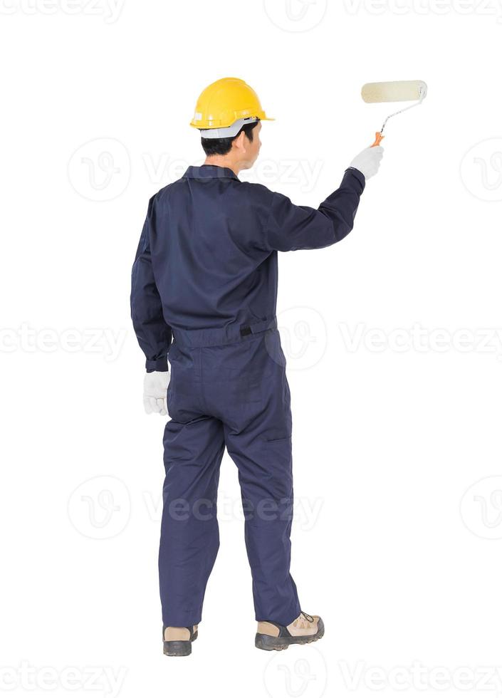 Worker in a uniform using a paint roller is painting invisible floor photo