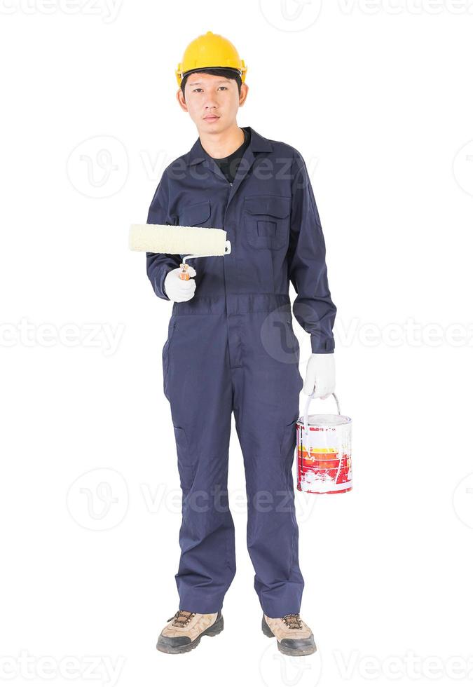 Worker in a uniform using a paint roller is painting invisible wall photo