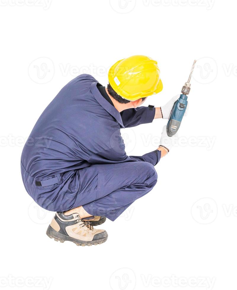 Handyman in unifrom sitting with his electric drill photo