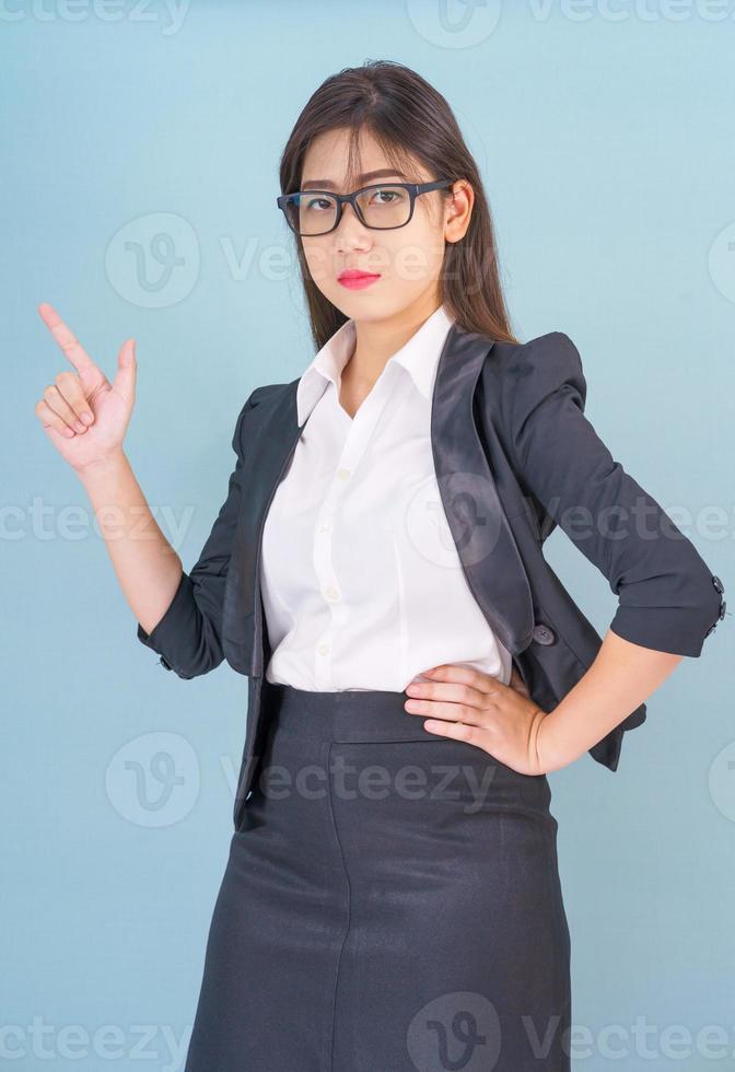 Business woman in suit with finger pointing up photo