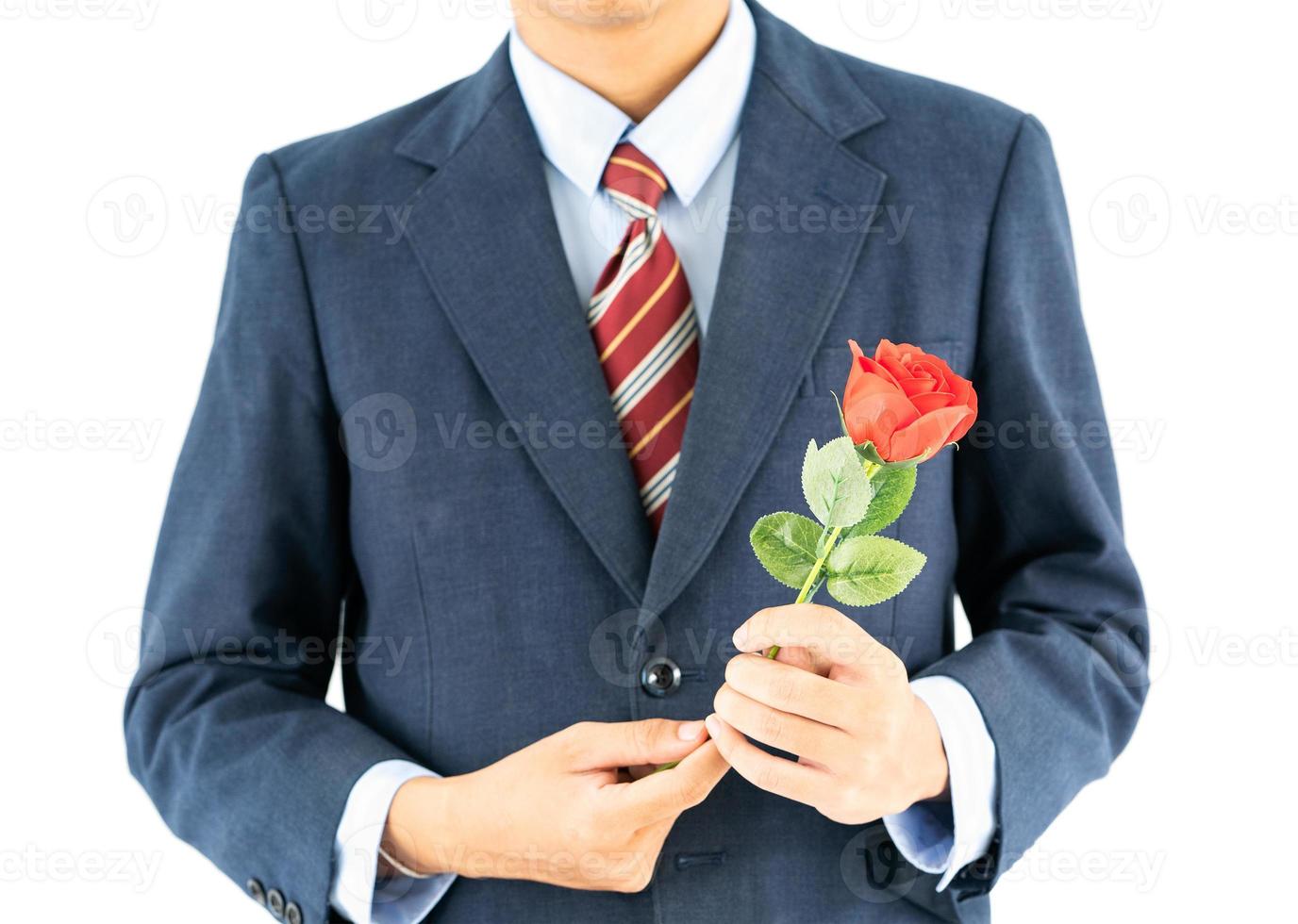 Businessman in suit with red rose on white photo