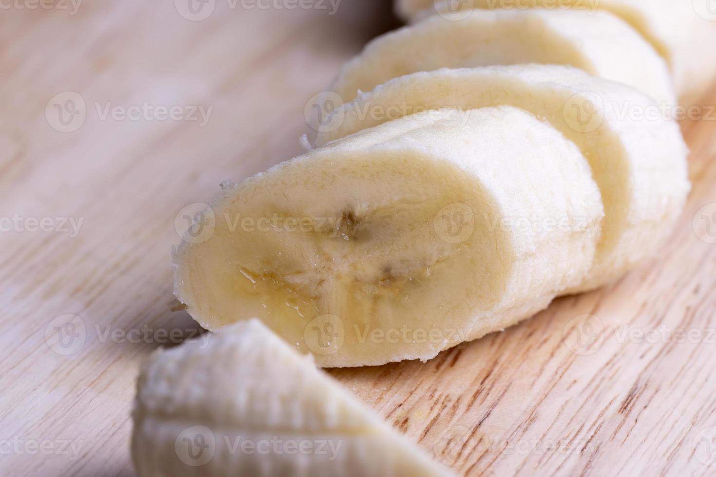 Sliced ripe banana on a cutting board photo