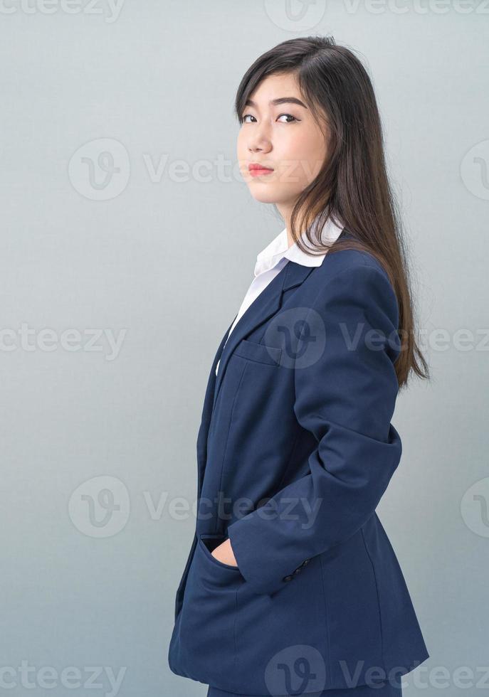 Portrait of asian business woman standing on gray photo